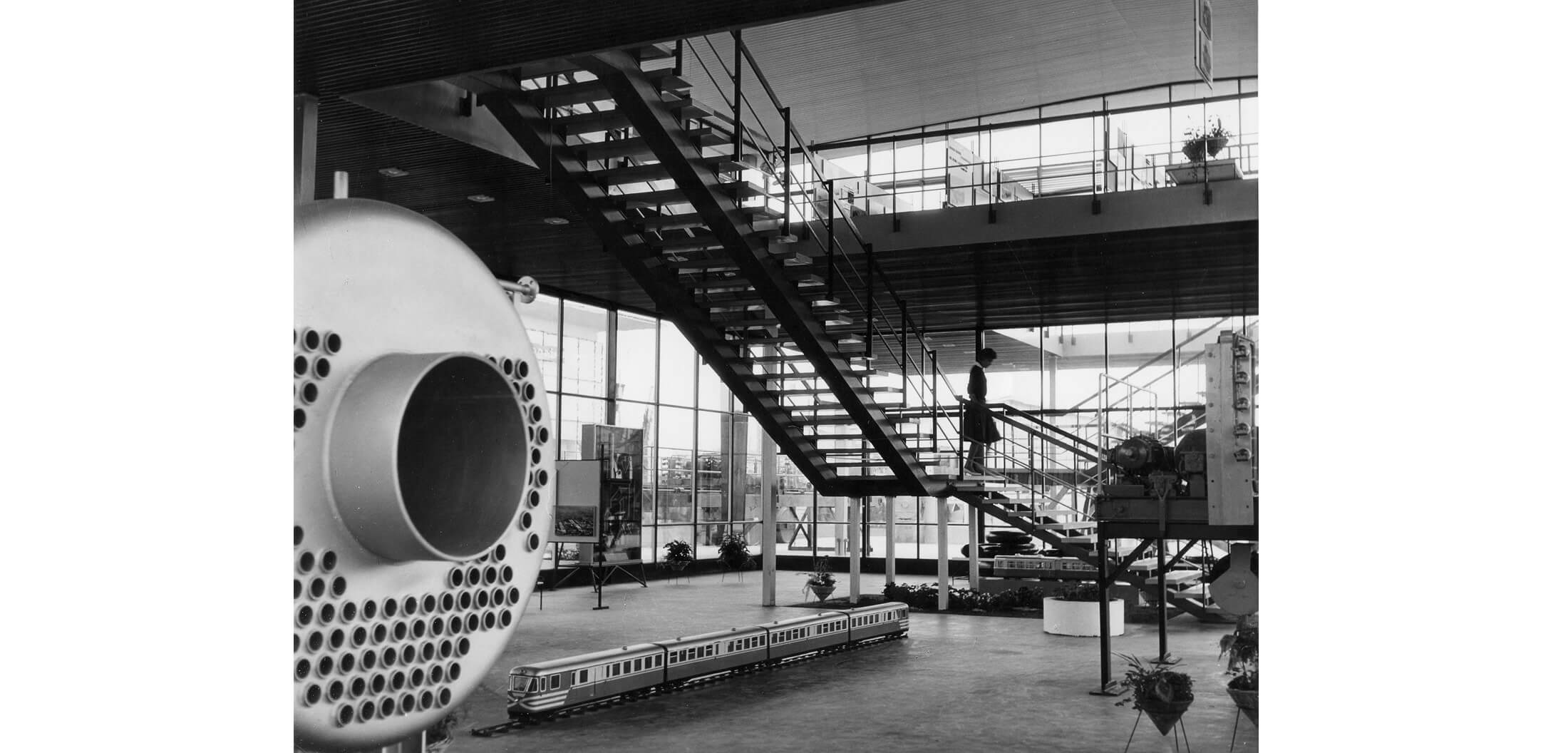 Completed interior of the Đuro Đaković factory exhibition pavilion at Zagreb Fair, view of ground floor exhibition space and stairs to gallery, 1961 (photo: Vilko Zuber)